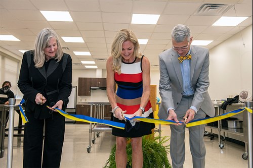 Amy Bircher, Beth Shorrock and Darrell Donahue cut the ribbon on the new Amy A. Bircher Textiles Laboratory at West Virginia University