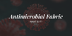 Close-up of a red microbe with text overlay: “Antimicrobial Fabric – What Is It?” on a dark background.