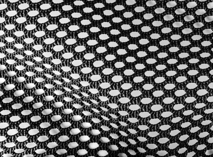 Close-up of 1996 12SD fabric in black, featuring a structured hexagonal mesh pattern designed for durability, breathability, and versatile performance applications.