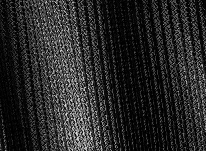 Close-up of 1925SD fabric in black, showcasing its textured warp knit construction ideal for structured, breathable, and durable textile applications.