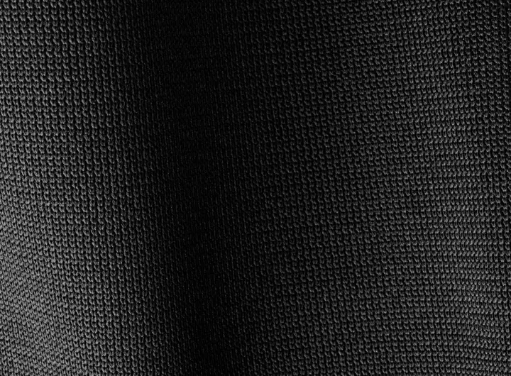 Close-up of 1920SD fabric in black, featuring a dense, textured knit pattern designed for durability, flexibility, and performance across industrial applications.