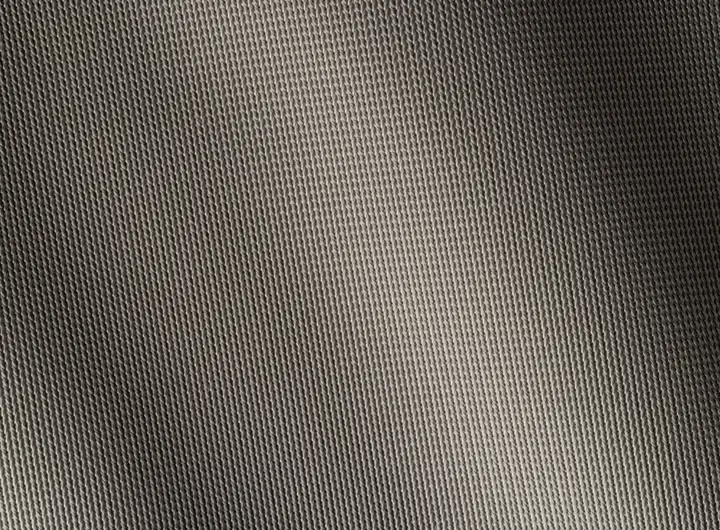Close-up of 1910 fabric in silver, showcasing a fine, uniform knit texture designed for breathability, strength, and versatile performance in various applications.