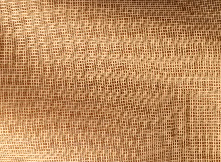 Close-up of 417 fabric in tan, featuring a tightly woven open mesh pattern designed for strength, breathability, and versatile industrial or safety applications.