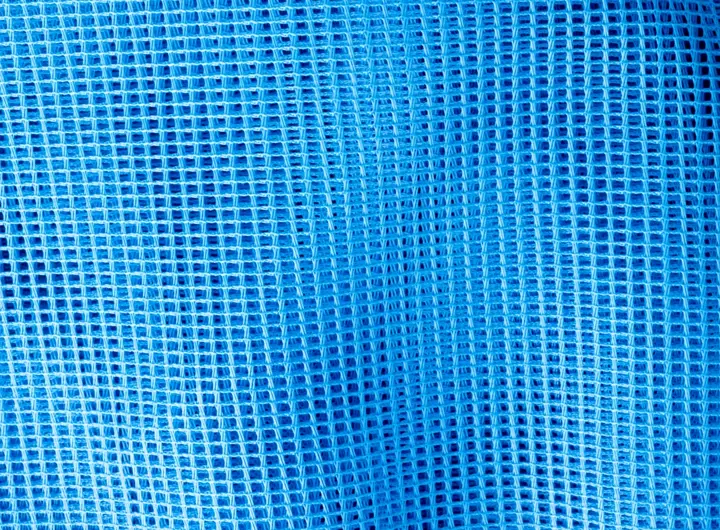 Close-up of 65 50 fabric in blue, showcasing a tightly woven mesh grid pattern ideal for filtration, support, or industrial textile applications.